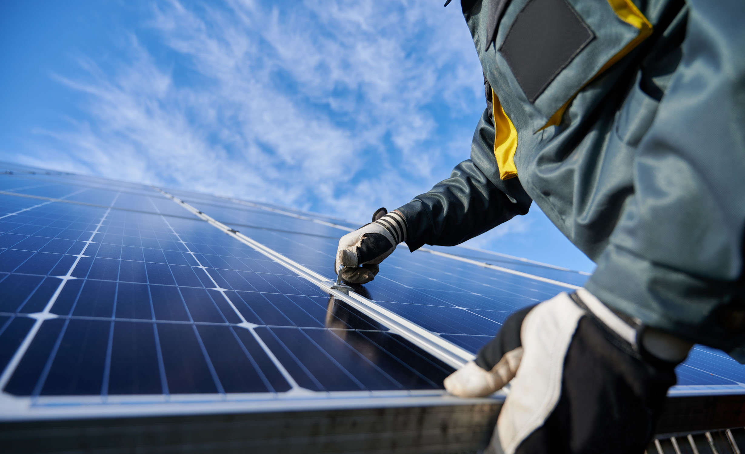 A Solar Energy Partners employee doing maintenance on solar panels.