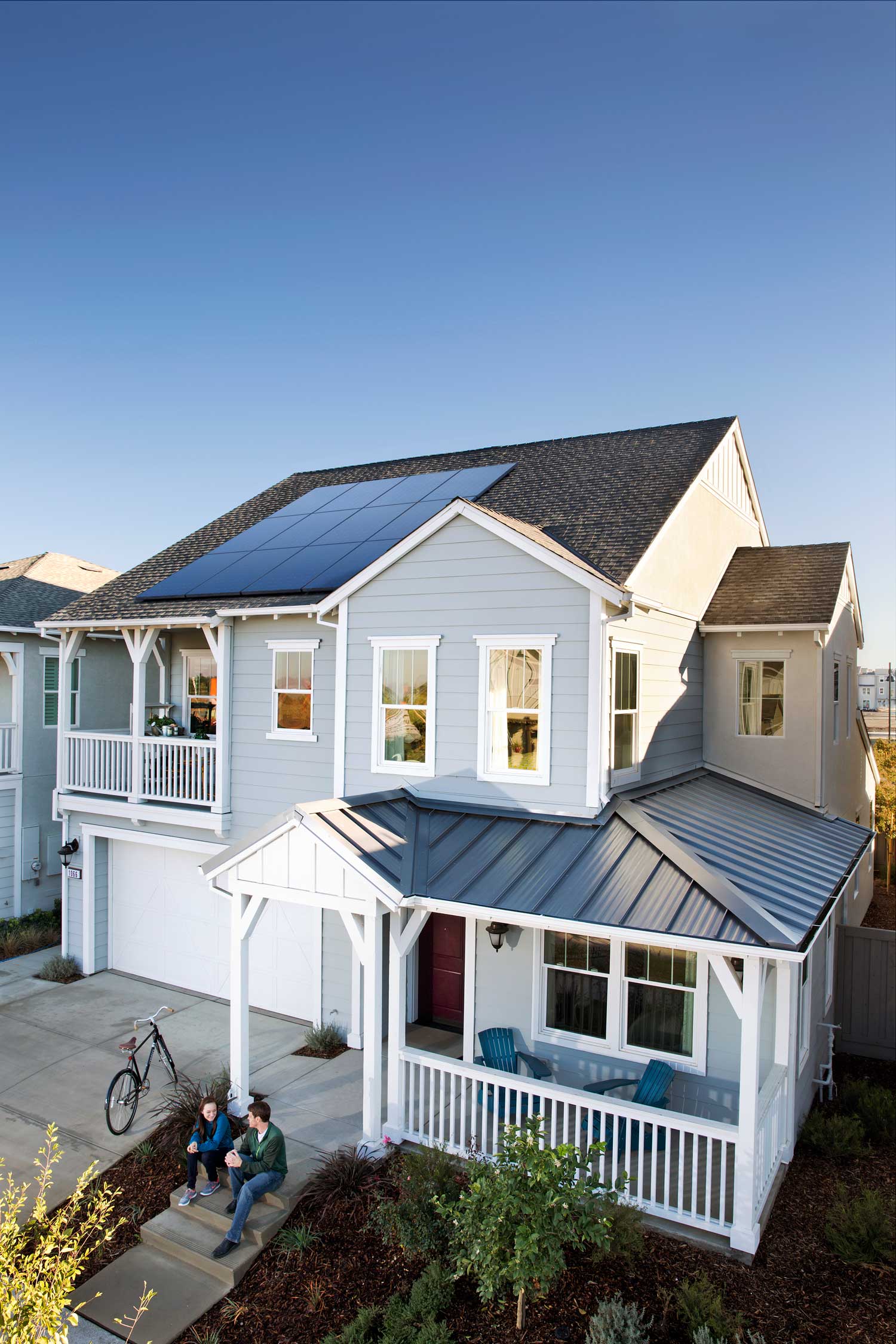 A small white house with freshly installed solar panels provided by Solar Energy Partners.